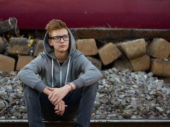 Portrait of young man sitting outdoors