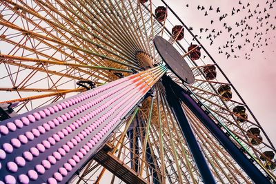 Low angle view of ferris wheel against clear sky