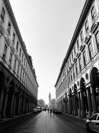 Street amidst buildings against sky in city