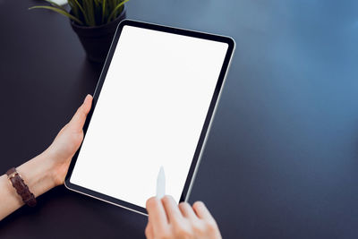 Midsection of man using mobile phone