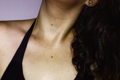 Close-up of woman against white background