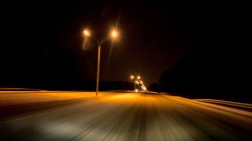 Illuminated tunnel at night