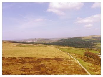 Scenic view of landscape against cloudy sky