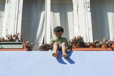 Rear view of boy against plants