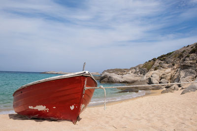 Sailboat on beach against sky