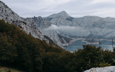 Scenic view of mountains and lake with trees in the foreground 