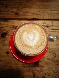 Close-up of coffee cup on wooden table