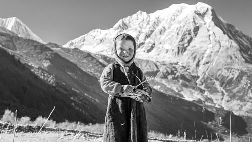 Portrait of smiling girl standing against mountain