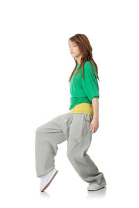 Side view of woman standing against white background