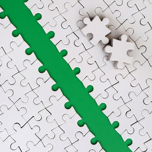 Close-up of jigsaw puzzle against green background