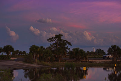 Scenic view of lake against sky at sunset