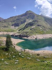 Scenic view of lake and mountains against sky