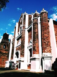 Low angle view of buildings against blue sky