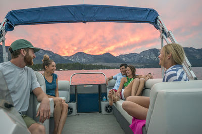 A group of friends boating on lake tahoe at sunset, ca