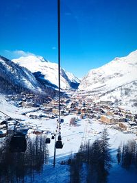 Scenic view of snowcapped mountains against blue sky