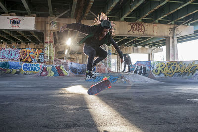 A young man skateboarding.