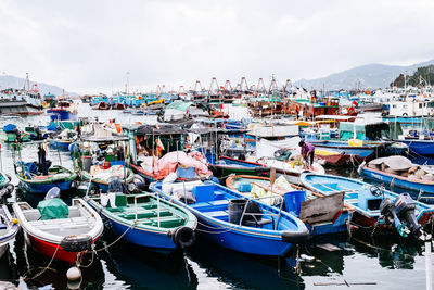 Fishing boats moored at harbor in city