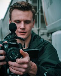Portrait of young man photographing