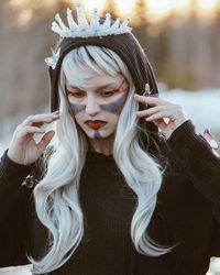 Close-up of young woman with halloween make-up and costume