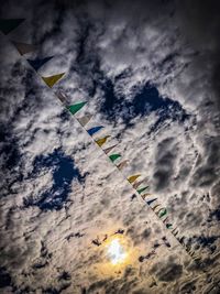 Low angle view of flags against sky