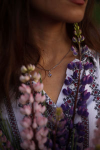 Close-up of woman with pink flowers