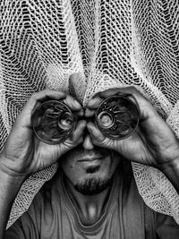 Close-up of man looking through glass