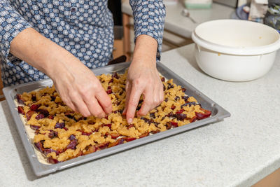 Midsection of man preparing food in kitchen