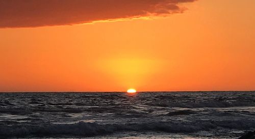 Scenic view of sea against romantic sky at sunset