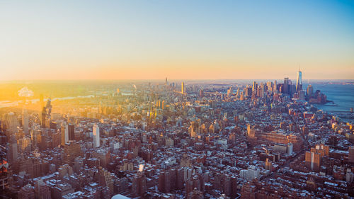 Aerial view of townscape against sky during sunset