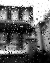 Close-up of water drops on window during rainy season