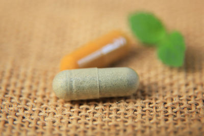 Close-up of pills spilling from bottle