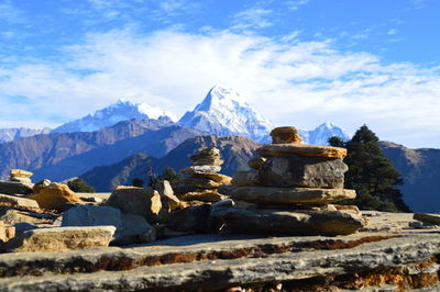 Stones at annapurna conservation area against snowcapped mountain