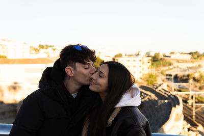 Boy tenderly kissing his partner on the cheek