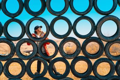 Full frame shot of man climbing outdoor play equipment made of tires