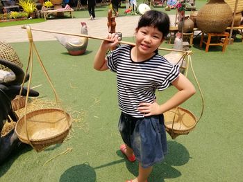 Portrait of boy holding while standing outdoors