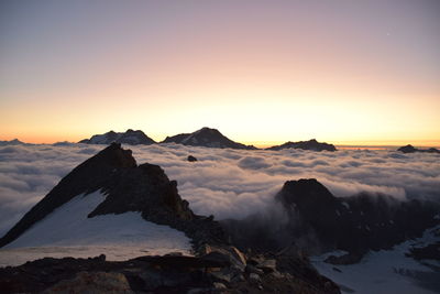 Scenic view of volcanic mountain against sky during sunset