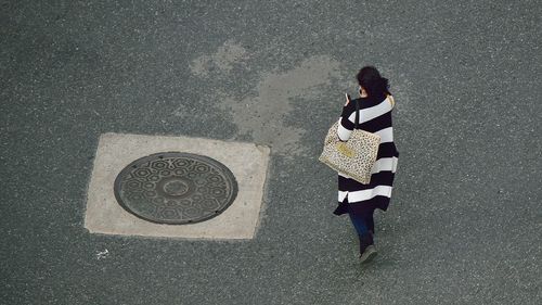 High angle view of woman standing on street