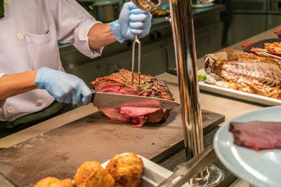 Midsection of man preparing food