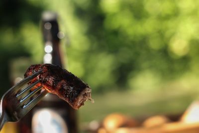 Close-up of bratwurst on fork