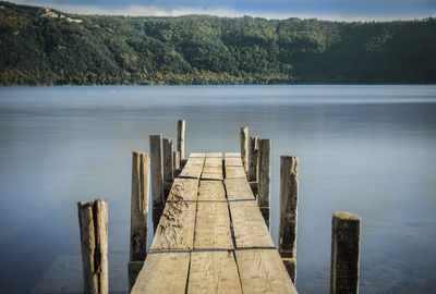 Wooden posts on pier over lake