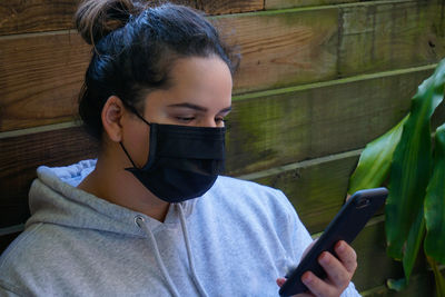 Portrait of woman holding mobile phone