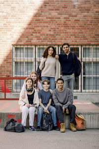 Portrait of smiling male and female students in high school campus