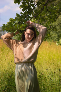 Portrait of smiling woman standing on field