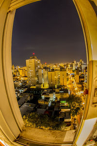 High angle view of buildings against sky seen through glass window