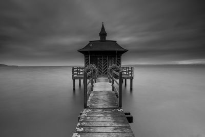 Pier over sea against sky