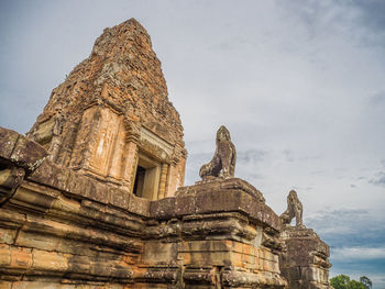 Low angle view of old temple building against sky