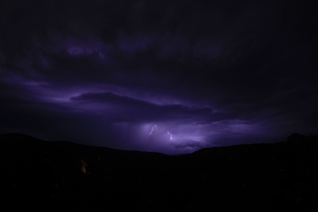 night, sky, beauty in nature, cloud, darkness, lightning, power in nature, scenics - nature, mountain, storm, thunderstorm, environment, dramatic sky, nature, no people, dark, thunder, landscape, silhouette, star, awe, storm cloud, purple, warning sign, outdoors, mountain range, astronomy, atmospheric mood