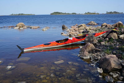 Scenic view of kayak on seaside against sky