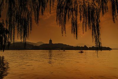 Scenic view of lake against sky during sunset