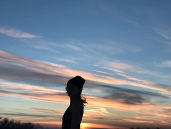 Silhouette man standing against sky during sunset